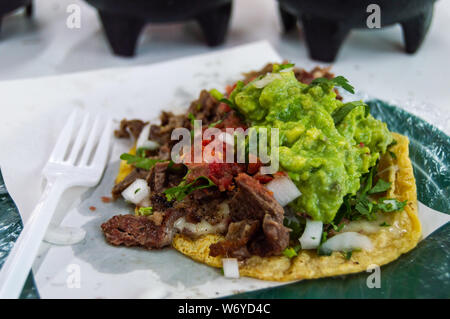 Boeuf grillé (Carne asada) quesadilla, servi dans un taco shop Tijuana avec guacamole, tomates, oignons et coriandre Banque D'Images