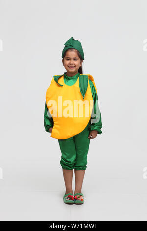 Girl dressed up a mango Stock Photo