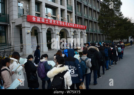 Les candidats à l'examen d'entrée de troisième cycle 2018 faire les préparatifs finals comme ils en file d'attente de l'examen au sein de l'Université de Renmin Uni Banque D'Images