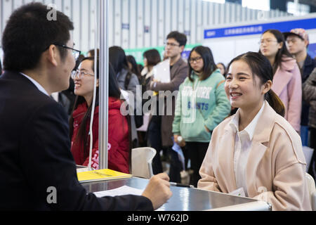 --FILE--un diplôme chinois et demande d'emploi parle avec l'aide d'un intervieweur pour chercher de l'emploi à un salon de l'emploi dans la ville de Nanjing, de Jiangsu est provinc Banque D'Images