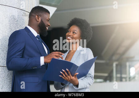 Un couple de partenaires d'affaires de sourire et le contact visuel Banque D'Images