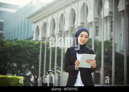 Femme musulmane travaillant sur pc de table, les voyages d'affaires de plein air concept. Banque D'Images