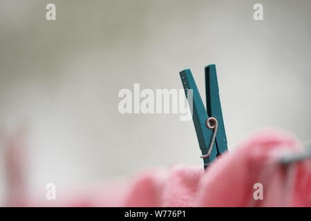 Clothespin détient des vêtements sur une corde, macro photo, vue de côté Banque D'Images