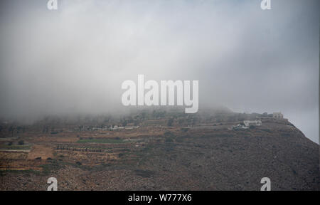 Les nuages entourent le monastère du prophète Elias au sommet Le sommet le plus élevé de Santorin, le mont Profitis Ilias Banque D'Images