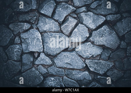 Mur en pierre sombre arrière-plan. Abstract grunge gris texture. Surface de granit noir, marbre. Modèle naturel pour l'art du design. Rock texturé. La maçonnerie en brique. Banque D'Images