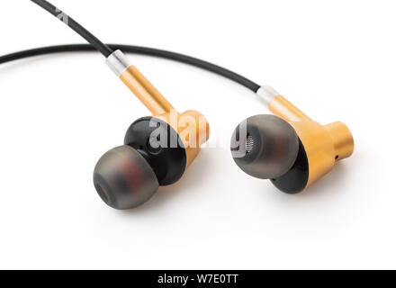 Close up of golden ear buds isolated on white Banque D'Images