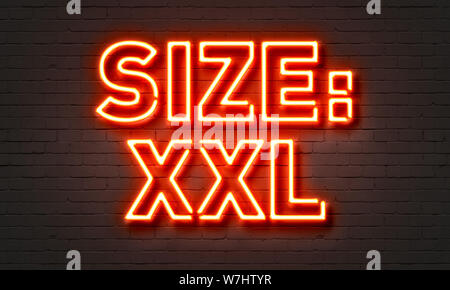 Taille XXL neon sign on brick wall background Banque D'Images