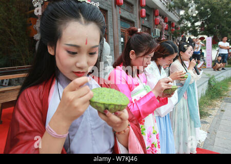 Femmes chinoises habillés en costumes traditionnels de prendre part à un événement culturel pour célébrer le prochain Festival Qixi, également connu sous le nom de Chinese Valenti Banque D'Images