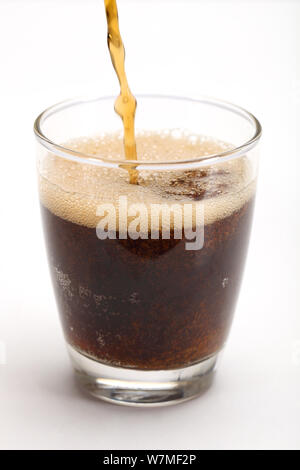 Soft drink being poured into a glass Stock Photo