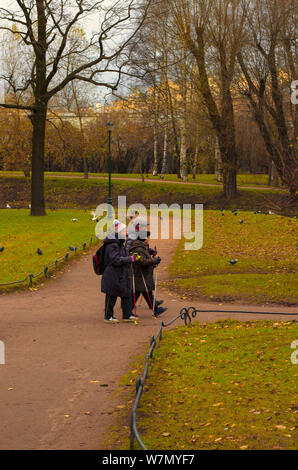 Saint Petersburg, Russie - 16 novembre 2018 : Trois personnes âgées engagées dans la marche nordique dans le parc sur un jour nuageux en fin d'automne Banque D'Images