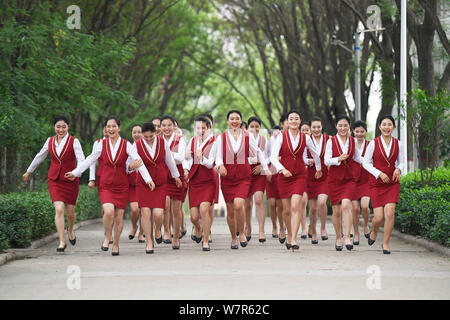 Les femmes diplômées des principaux agents de bord habillés en uniforme d'hôtesse de l'air, prendre des photos de gradation à Taiyuan city, au nord la province de Shanxi, Banque D'Images