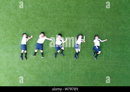 --FILE--Les enfants de la maternelle expérimentale Fujian Normal University joint posent pour une photo créative de leur diplôme à Fuzhou City, au sud-est de la Chine Banque D'Images