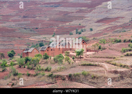 Maisons dans paysage érodé le long de la RN7 entre Antsirabe et Fianarantsoa, Madagascar. Banque D'Images