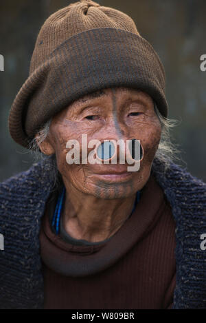 Femme Apatani dans les champs. La femme a des tatouages faciaux et traditionnel-nez / Yapin Hul composé d'une tranche de canne. C'était de rendre son apparence peu attrayante pour les hommes d'autres tribus, une pratique désormais interdite. Tribu Apatani, Ziro Vallée, contreforts de l'Himalaya, de l'Arunachal Pradesh.Le nord-est de l'Inde, novembre 2014. Banque D'Images