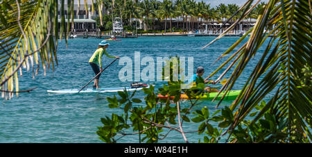 Paddleboarder Stand-up et les kayakistes dans le joyau de l'eau bleu-Jupiter Inlet à marée montante dans la région de Jupiter, comté de Palm Beach, en Floride. (USA) Banque D'Images