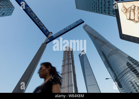 --FILE--un piéton passe devant (de gauche) Jinmao Tower, le Centre mondial des finances de Shanghai et le Shanghai Tower dans le quartier financier de Lujiazui Banque D'Images