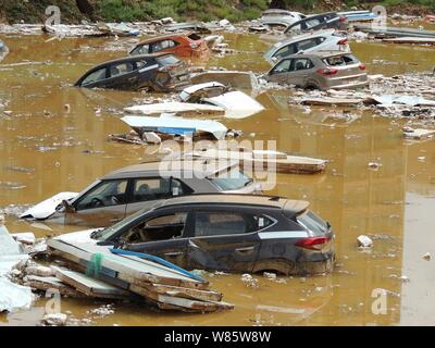 Les voitures privées sont submergés dans l'eau après avoir été lavés par les inondations causées par un orage dans une fosse de l'aire de stationnement dans un quartier résidentiel Banque D'Images