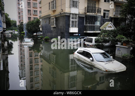 Les voitures privées sont submergées par l'eau à un quartier résidentiel gorgé à Wuhan, province du Hubei en Chine centrale, le 13 juillet 2016. La Chine a déclaré jeudi Banque D'Images