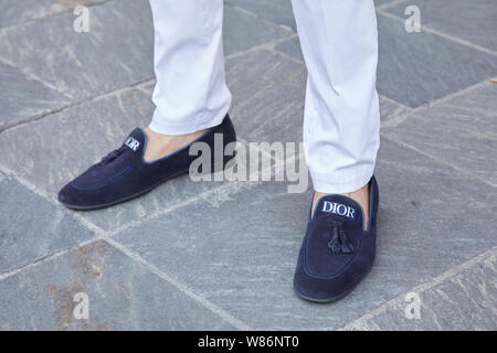 MILAN - JUNE 16: Woman with white and blue Louis Vuitton sneakers walking  before Marni fashion show, Milan Fashion Week street style on June 16, 2018  Stock Photo - Alamy