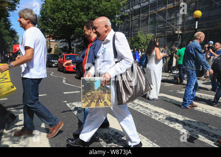 Londres, Royaume-Uni. 8e août 2019. Les fans de musique de recréer la célèbre promenade sur un passage clouté par Beatles John Lennon, Paul McCarney, Ringo Starr et George sur le 50e anniversaire de l'album Abbey Road sorti le 8 août 1969. Credit : amer ghazzal/Alamy Live News Banque D'Images