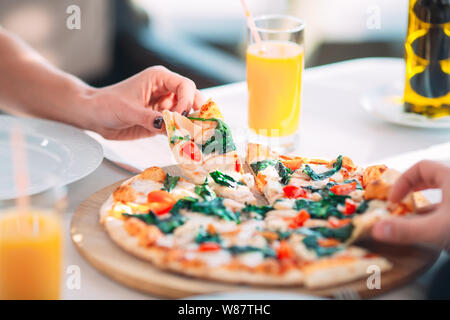 Un couple mange de la pizza dans un restaurant. Banque D'Images