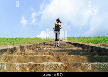 Young woman running sport piscine a l'étage on blue sky Banque D'Images