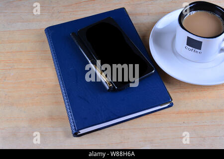 Ordinateur portable blanc, stylo, smartphone et tasse de café sur le bureau Banque D'Images