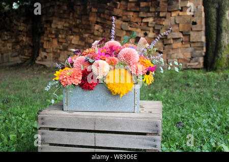 Arrangement floral dans la case en face de fond de bois Banque D'Images