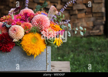 Arrangement floral dans la case en face de fond de bois Banque D'Images