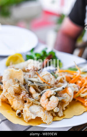 Mélange de fruits de mer frits. Déjeuner de fruits de mer au restaurant. Des plats italiens traditionnels. Les crevettes, les calmars et les petits poissons frits Banque D'Images