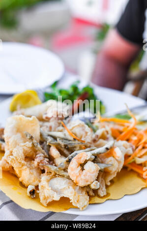 Mélange de fruits de mer frits. Déjeuner de fruits de mer au restaurant. Des plats italiens traditionnels. Les crevettes, les calmars et les petits poissons frits Banque D'Images
