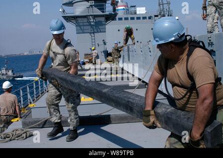 Circuit de l'armée américaine. Anthony Phillips (à gauche) et de la Marine Maître de 2e classe Laurent Gonzalez, faire une poutre en bois à l'appui d'un fardage fort au cours de l'appui humanitaire sur la rive 2007 à Puerto Quetzal, au Guatemala, le 6 février 2007. Environ 1 300 militaires américains et de femmes représentant la Marine, l'armée, la Garde nationale, et les forces de réserve sont les participants de l'exercice de simulation de catastrophe qui implique le transport de l'équipement de l'ingénieur deux groupes de travail. Phillips est jointe à la 567e compagnie de transport de fret d'admission alors que Gonzalez est joint à la Marine Cargo Handling Ba Banque D'Images