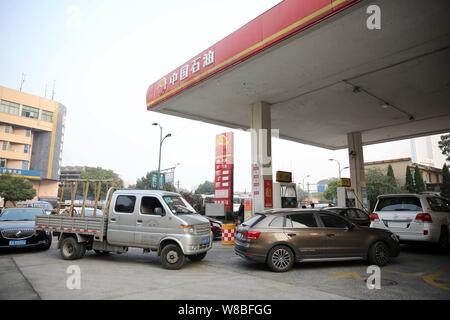 --FILE--voitures font la queue jusqu'à faire le plein à une station-service de PetroChina, filiale de la CNPC (China National Petroleum Corporation), à Hangzhou, à l'est Ch Banque D'Images