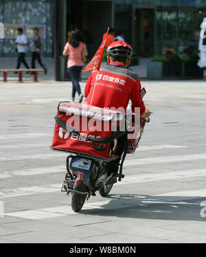 --FILE--un livreur chinois Baidu est en ligne de service de livraison de nourriture en waimai.baidu.com un vélo électrique pour fournir de la nourriture sur une route à Pékin, Ch Banque D'Images