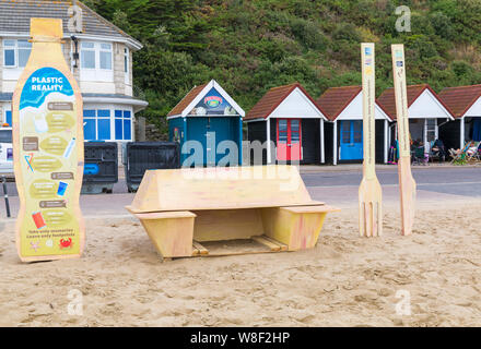 Bournemouth, Dorset, Royaume-Uni. 9 août 2019. Une nouvelle installation d'art temporaire arrive à Bournemouth Beach, comprenant une boîte de sortie, des couverts en plastique et une bouteille en plastique à usage unique, toutes faites de bois avec des messages sur la pollution du plastique et son effet sur la faune. Conçu par l'artiste Jack Raisey des installations similaires ont été installées sur les plages de Lyme Regis et West Bay. Crédit : Carolyn Jenkins/Alay Live News Banque D'Images