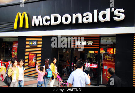 --FILE--piétons passent devant un restaurant de fast-food McDonald's à Chongqing, Chine, le 20 septembre 2015. McDonald's Shanghai chaînes seront la firs Banque D'Images