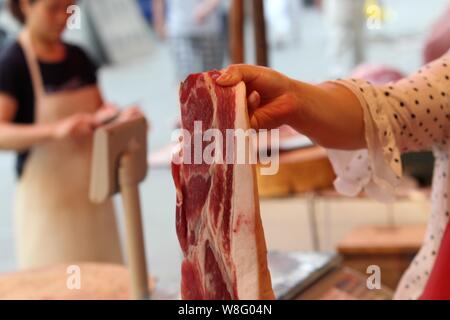 --FILE--Un vendeur vend chinois au porc un marché libre dans la ville de Nantong, province du Jiangsu en Chine de l'Est, 7 juillet 2011. Près d'un demi-milliard de dollars millepertuis Banque D'Images