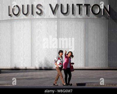 --FILE--piétons devant une boutique de mode de Louis Vuitton (LV) à Shanghai, Chine, 12 mai 2015. LVMH Moet Hennessy Louis Vuitton se dit Mon Banque D'Images