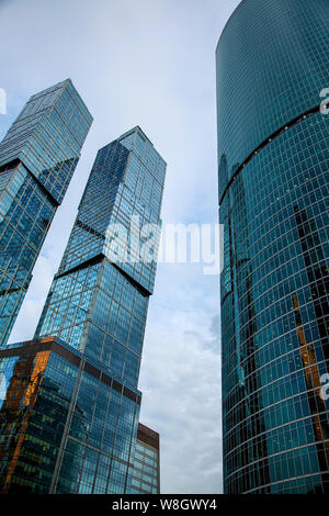 Vue sur le haut de gratte-ciel en verre moderne contre le ciel bleu. Fond d'architecture Banque D'Images