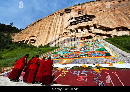 Un immense culte Lamas de Thangka de l'ensoleillement au cours de Bouddha Bouddha Festival (Shaifo Jie) à Mati Temple dans Sunan Yugur comté autonome, dans les C Banque D'Images