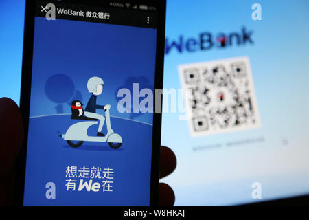 --FILE--un résident chinois local utilise l'application mobile de la banque en ligne chinois de WeBank sur son smartphone à Shanghai, Chine, 18 janvier 2015. WeBank, Banque D'Images