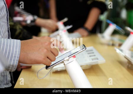 - Un fichier clients--essayer l'iPhone d'Apple les smartphones 6 dans un magasin à Shanghai, Chine, 17 octobre 2014. Apple Inc. prévoit d'introduire un prog Banque D'Images