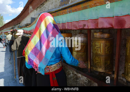 --FILE--une femme habillé en costume tibétain tourne roues de prière dans le Palais du Potala à Lhassa, le sud-ouest de la Chine, région autonome du Tibet, 10 octobre 20 Banque D'Images