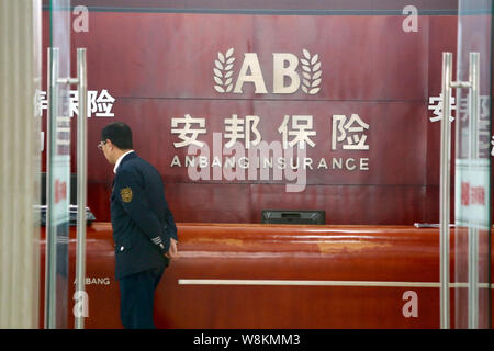 --FILE--un garde de sécurité chinois passe devant la réception de l'établissement d'une succursale d'assurance Shandong Tongya Plastic Technology à Shanghai, Chine, 25 décembre 2015. Anba assureur chinois Banque D'Images