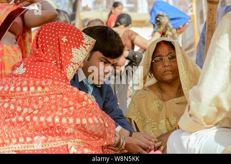 Mariés à une cérémonie de mariage hindou traditionnel indien sur les rives du Gange à Varanasi, Uttar Pradesh, Inde, Asie du Sud. Banque D'Images