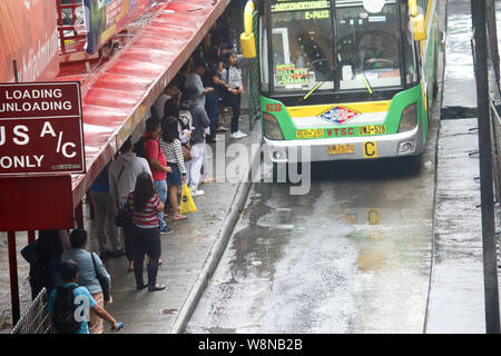 Les banlieusards sont en attente dans l'arrêt de bus pendant les heures de pointe en en début d'EDSA vendredi après-midi. Aux Philippines, il est illégal de conduire le lundi si le numéro de la plaque d'un véhicule se termine par un 1 ou 2 alors que le mardi, c'est 3 et 4. Le mercredi, c'est 5 et 6. Jeudi, 7 et 8. Enfin, le vendredi, c'est 9 et 0. Cette loi fait partie de la circulation unifiée du Programme de réduction de volume ou numéro de codage. Le programme vise à réduire la congestion routière, pendant les heures de pointe, en limitant les types de véhicules qui peuvent utiliser les principales voies publiques fondées sur le dernier chiffre de la plaque d'immatriculation du véhicule. (Pho Banque D'Images