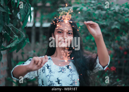 A girl Playing with sparklers. Banque D'Images