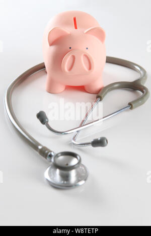 Close up of stethoscope with piggy bank Stock Photo