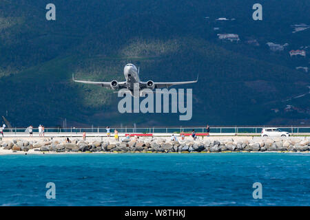 Plage d'avions à réaction commerciaux - quitte l'Aéroport Princess Juliana Maho Beach Sint Maarten, avion décollant sur l'eau bleu Caraïbes - avion Banque D'Images