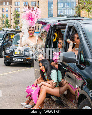 Lady Boys of Bangkok, Edinburgh Festival Fringe, Écosse, Royaume-Uni comme drag artistes Cram dans le taxi dans des costumes colorés Banque D'Images